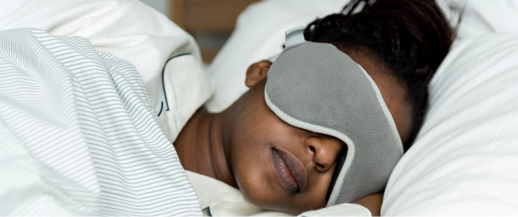 Femme qui dort en utilisant un masque pour les yeux, pour que son sommeil ne soit pas perturbé par la lumière