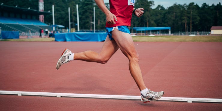 Runner with strong knees running on a track