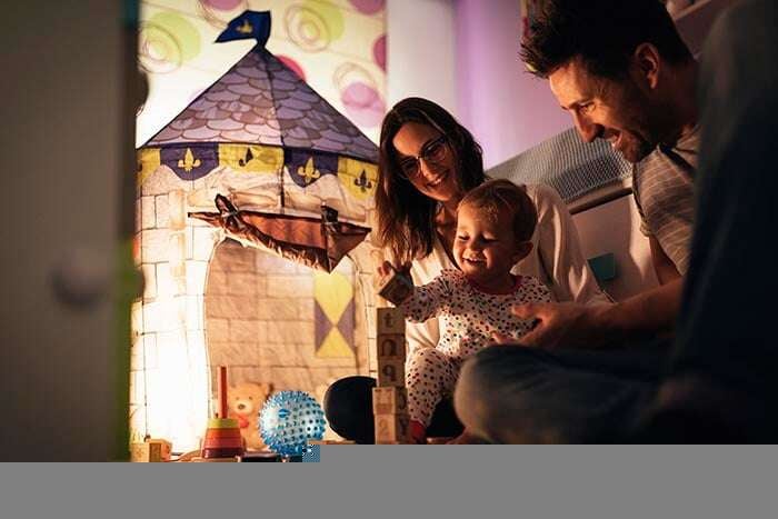 parents enjoying playing with their son at home