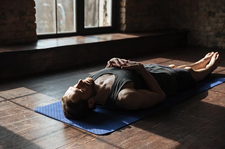 man practicing body scan meditation indoors