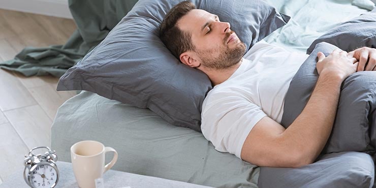 man sleeping on his bed