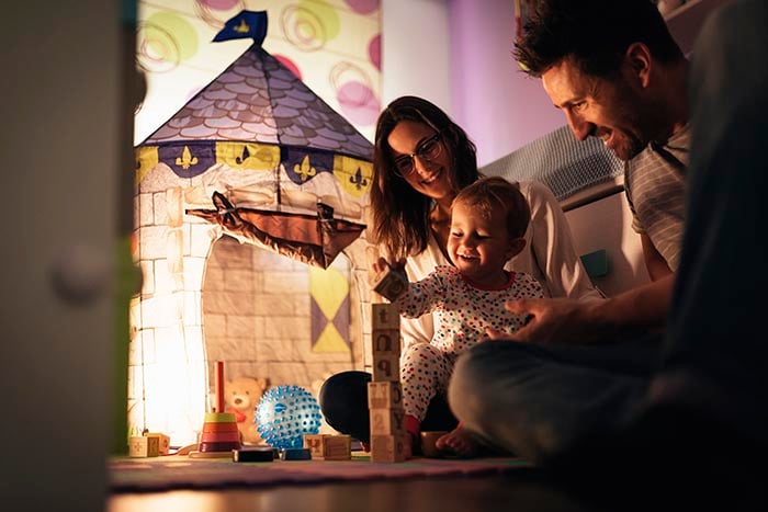 parents enjoying playing with their son at home