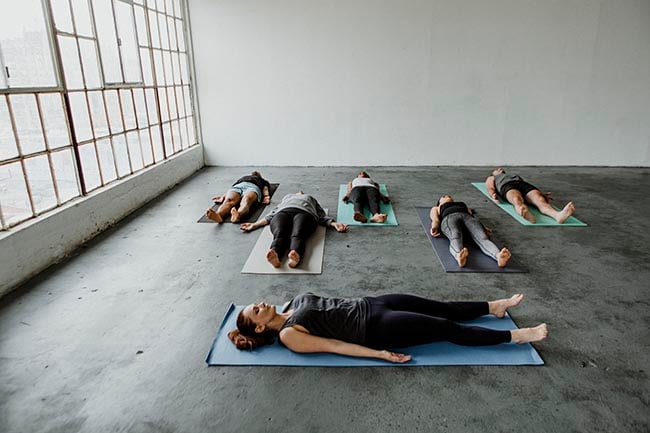 people exercising performing yoga nidra