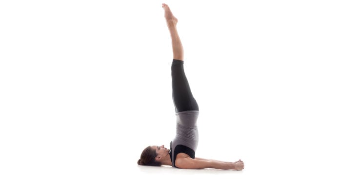 shoulder stand yoga pose performed by a woman