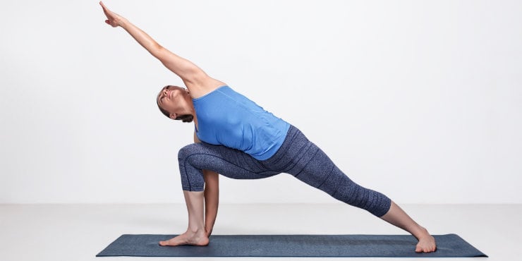 woman doing side angle pose in yoga