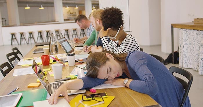 lavoratore stanco-al-tavolo-in-ufficio-che-ha-bisogno-di-aiuto-con-la-gestione-dello-stress-700
