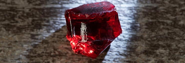 top-view-of-magical-red-crystal-with-light-on-wood-representing-root-chakra-crystal-and-color