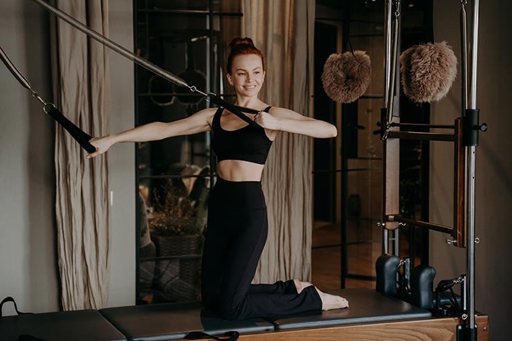 woman on pilates reformer exercising