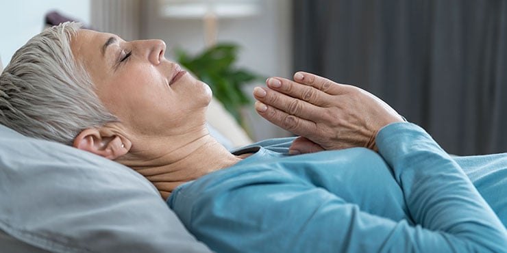 woman-practicing-meditation-before-sleeping-740