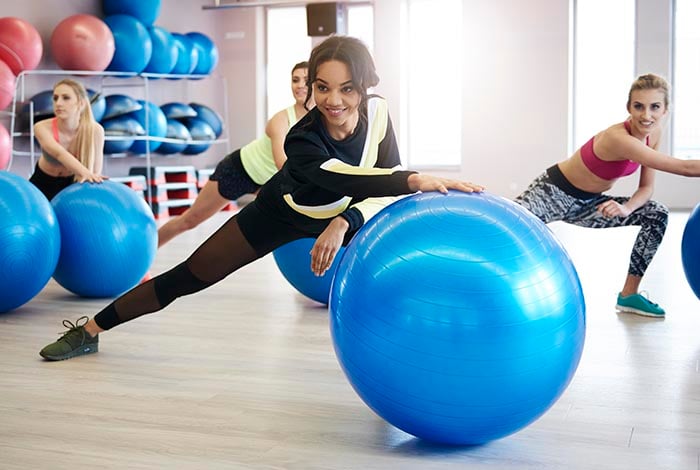 femmes faisant de l'exercice avec ballon de fitness et pilates et autres équipements