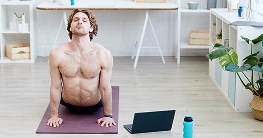 man doing yoga online in yoga for men