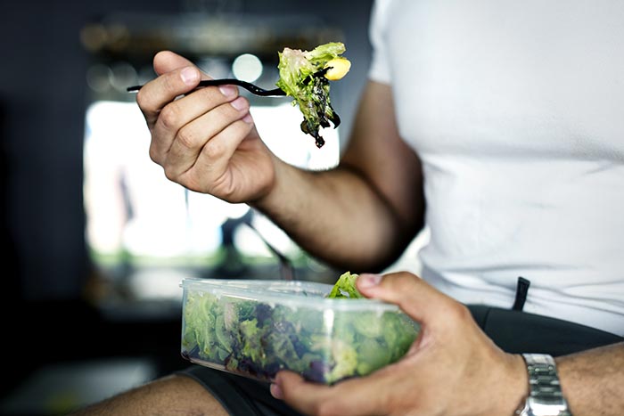 person enjoying mindful eating while eating a salad
