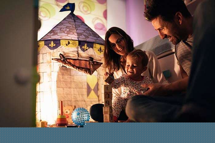 parents enjoying playing with their son at home