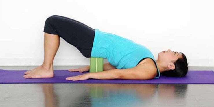 bridge pose with sacrum supported on yoga block